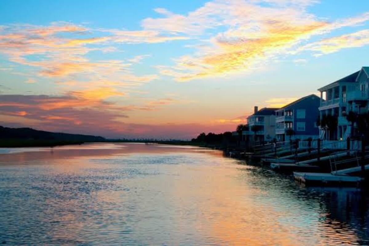 Sunset over the Intracoastal Waterway with waterfront homes and private docks near Barefoot Resort